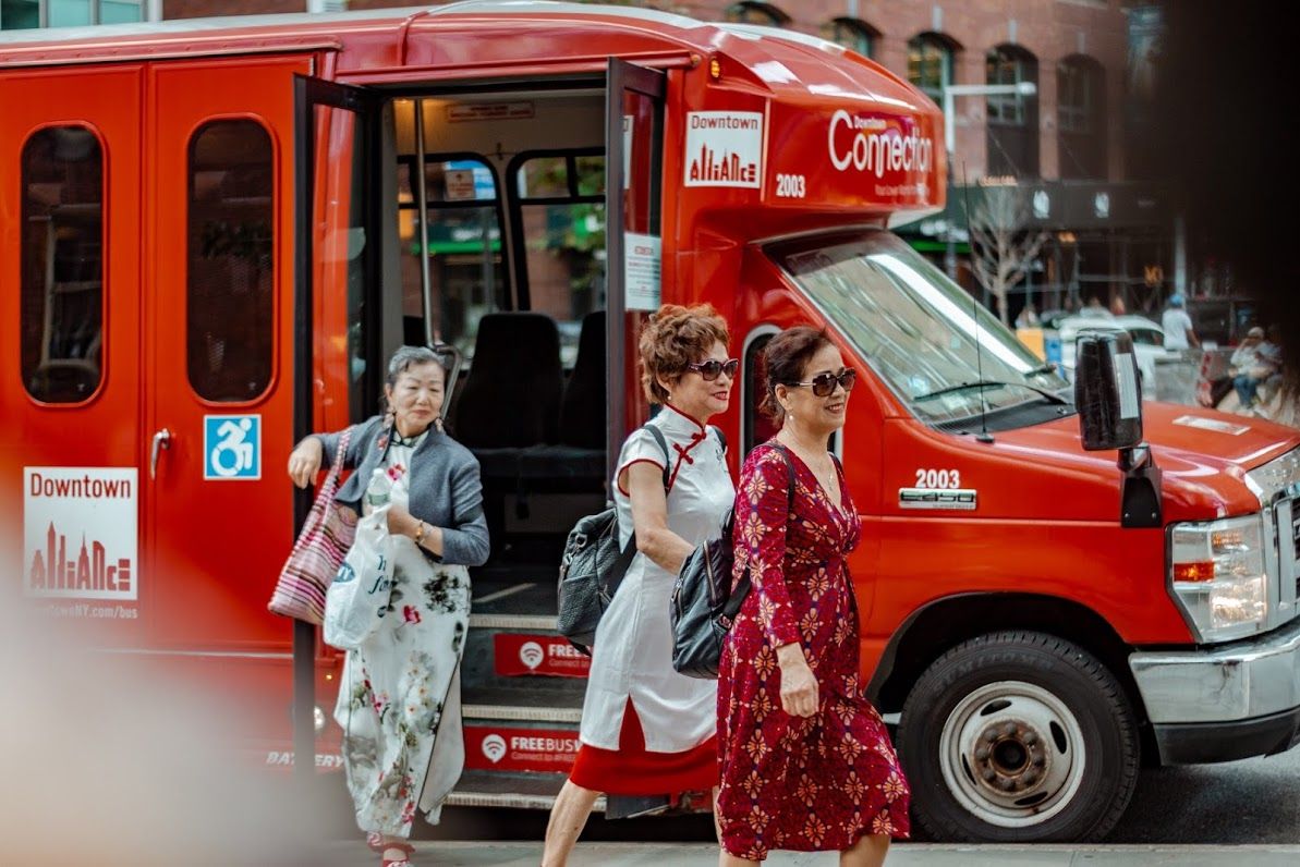 3 women in Chinese dress taking off the bus in New York: A photo by David Elikwu