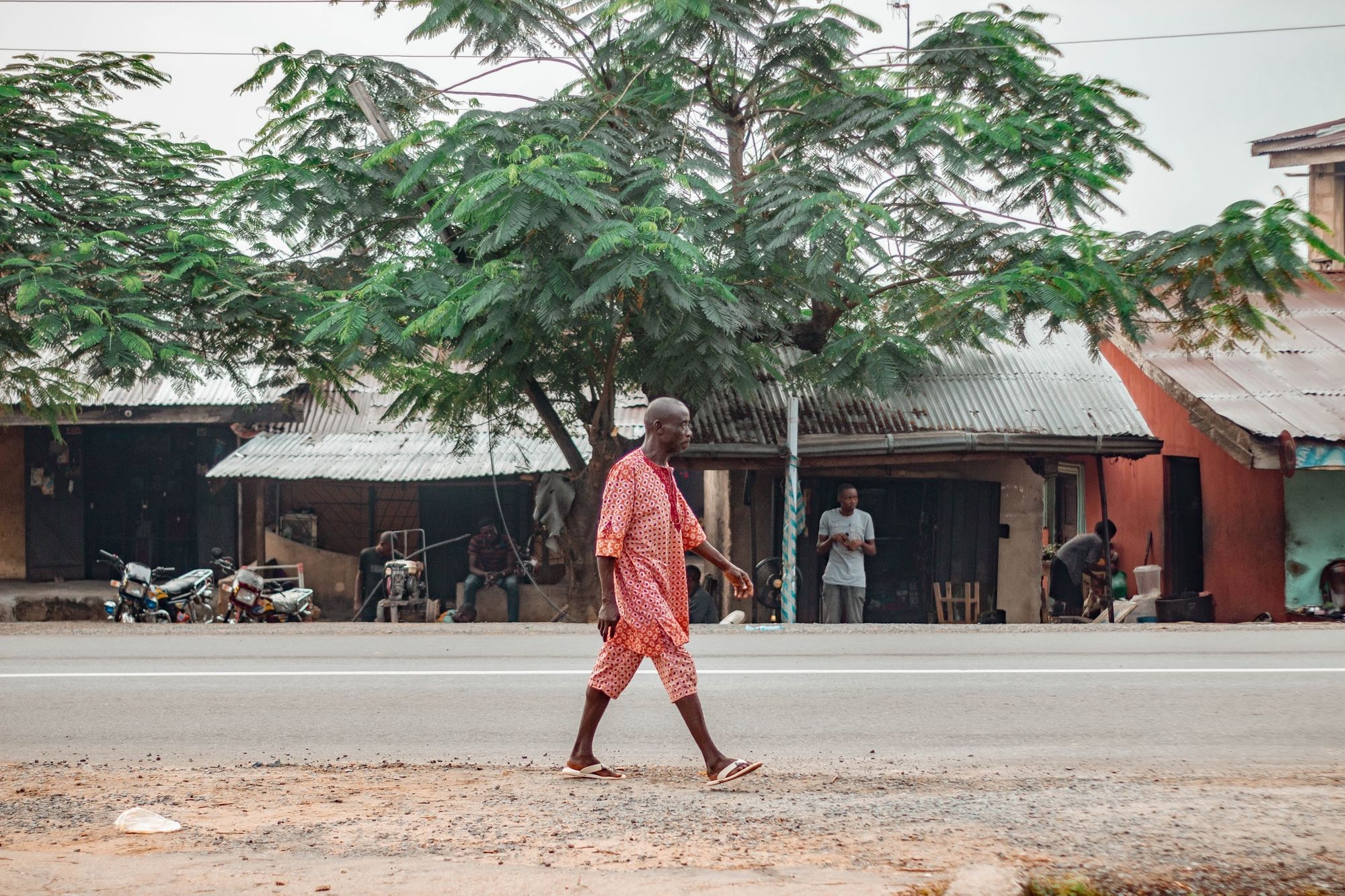An old man walking at the sidewalk in Calabar: A photo by David Elikwu