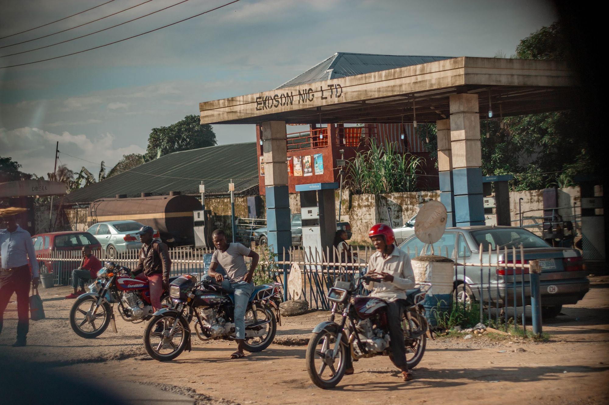 Three men each on their parked motorcycle in Ediba: A photo by David Elikwu