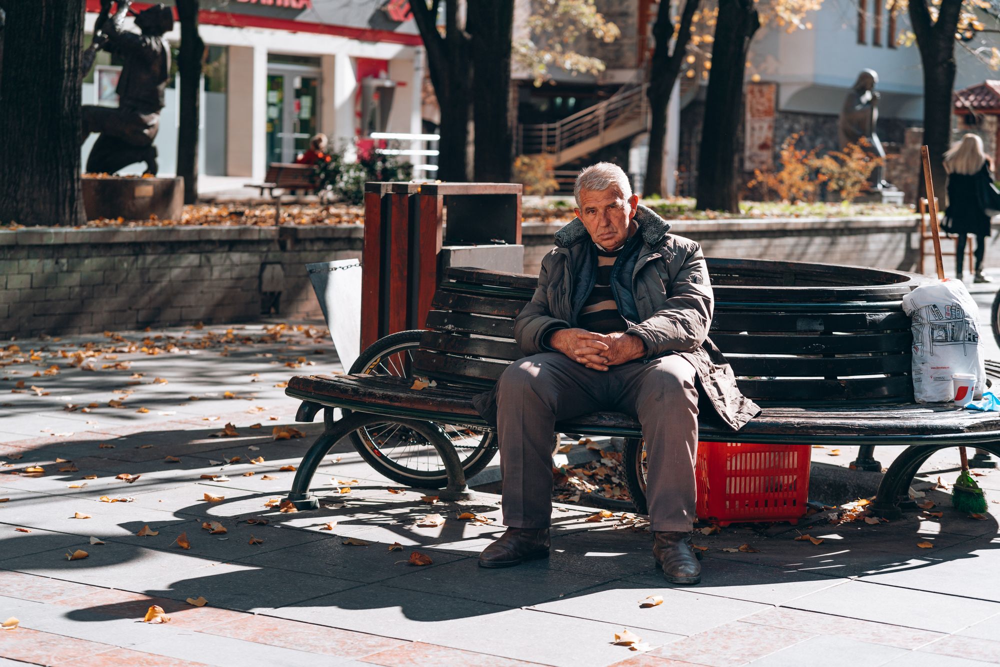 Photo by David Elikwu of old man on a bench looking into the camera. Taken in North Macedonia.